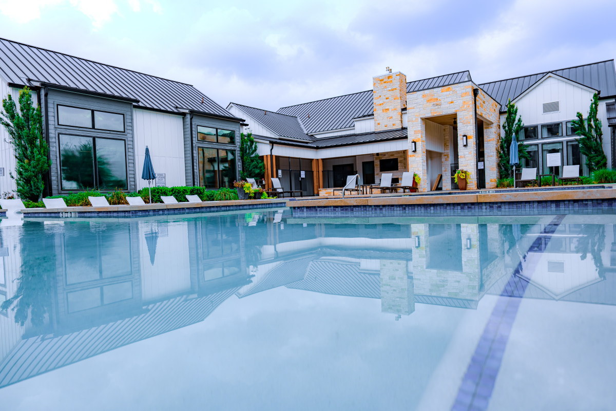 DSC06827 Poolside view with modern home or clubhouse in the background
