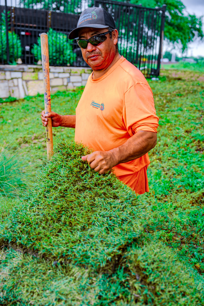 DSC06871 Person in an orange shirt standing on green grass